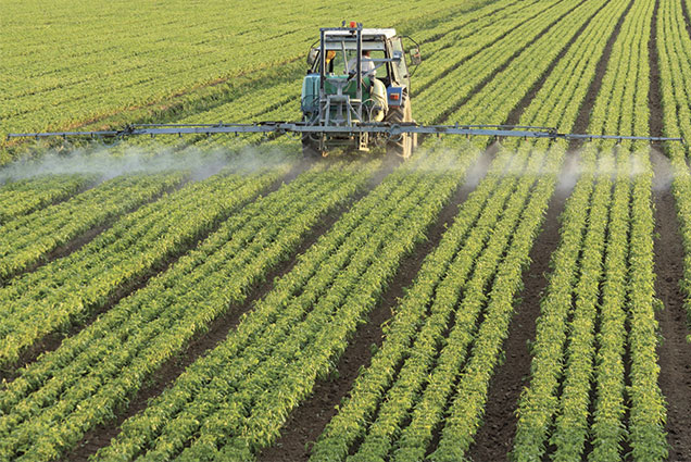Tractor Spraying Chemicals On a Field